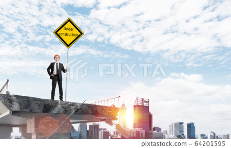 Confident engineer holding street safety sign. 64201595