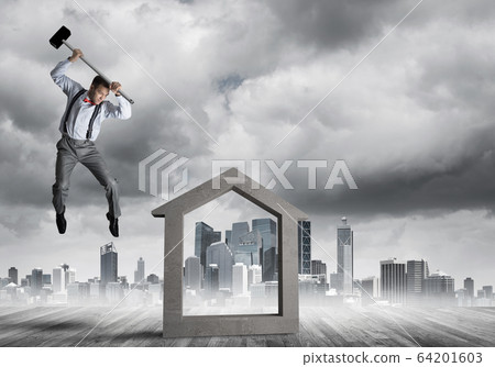 Manager man crashing stone home as symbol for real estate insurance 64201603
