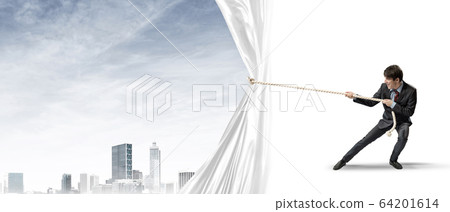 Young man opening white curtain and presenting modern city landscape 64201614