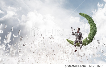 Businessman announcing something in loudspeaker and symbols fly 64201615