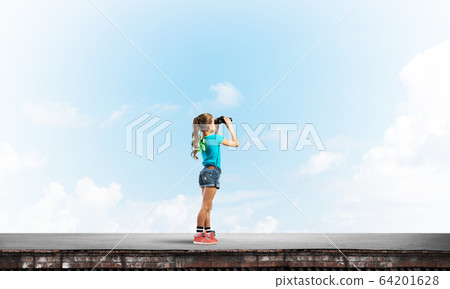 Concept of careless happy childhood with girl of school age looking in future Concept of careless happy childhood with girl of school age looking in future 64201628