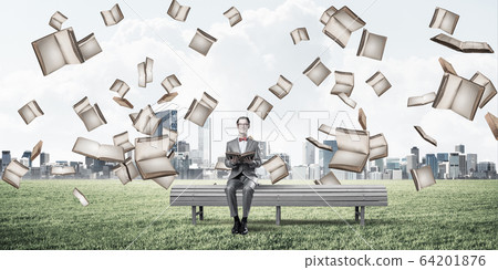 Young businessman or student studying the science in summer park Young businessman or student studying the science in summer park 64201876