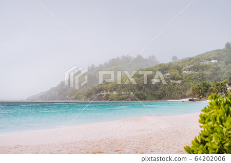 Tropical rain covered Anse Intendance beach on Mahe island in Seychelles Tropical rain covered Anse Intendance beach on Mahe island in Seychelles 64202006
