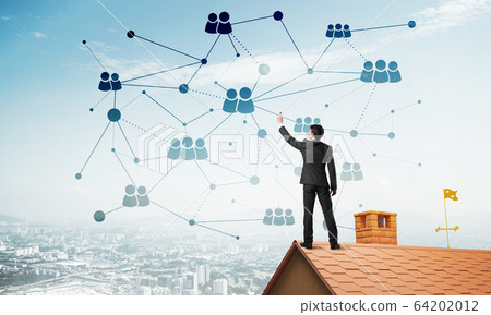 Businessman on house roof presenting networking and connection concept. Mixed media Businessman on house roof presenting networking and connection concept. Mixed media 64202012