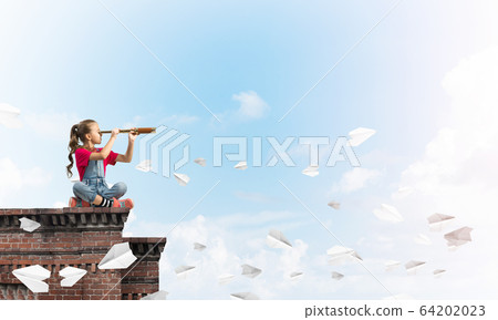 Concept of careless happy childhood with girl exploring this world Concept of careless happy childhood with girl exploring this world 64202023