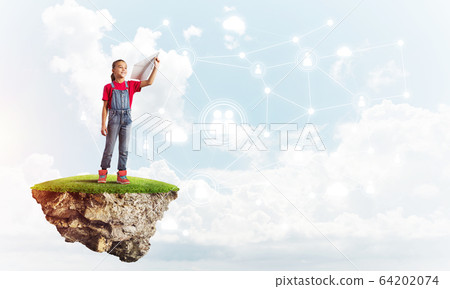Concept of careless happy childhood with girl dreaming about something Concept of careless happy childhood with girl dreaming about something 64202074