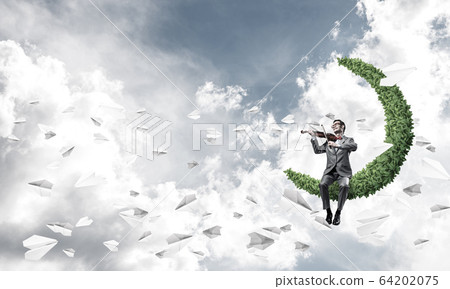 Handsome businessman play his melody and paper planes fly around 64202075