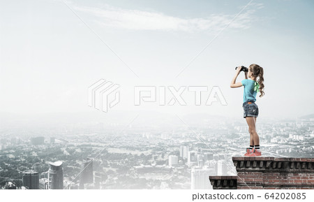 Concept of careless happy childhood with girl of school age look 64202085
