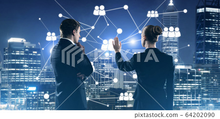 Concept of social connection and networking against night city view and partners working in cooperation Concept of social connection and networking against night city view and partners working in cooperation 64202090