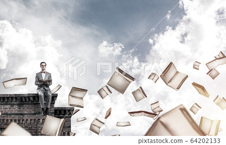 Young businessman or student studying the science and books flyi Young businessman or student studying the science and books flyi 64202133