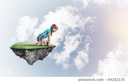 Concept of careless happy childhood with girl dreaming about something Concept of careless happy childhood with girl dreaming about something 64202135