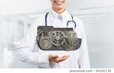 medicine worker presenting in her palms cloud computing concept as mechanism of cogwheels 64202136