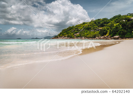 Beautiful long sandy Petite Anse beach at Mahe Island, Seychelles. Huge rainy clouds in sky. Holiday recreative vacation Beautiful long sandy Petite Anse beach at Mahe Island, Seychelles. Huge rainy clouds in sky. Holiday recreative vacation 64202140
