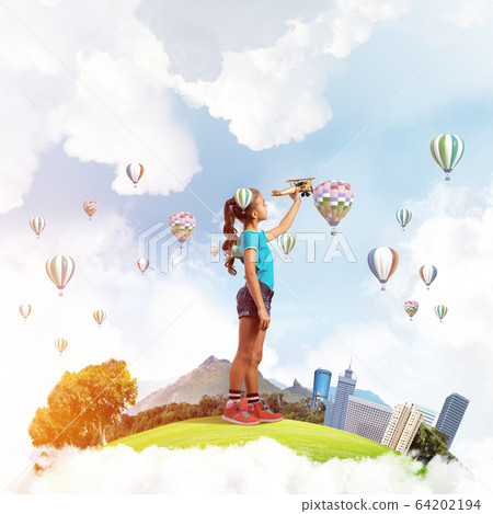 Concept of careless happy childhood with girl dreaming to become pilot Concept of careless happy childhood with girl dreaming to become pilot 64202194