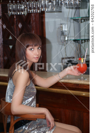 Young beautiful girl at the counter in the restaurant Young beautiful girl at the counter in the restaurant 64202768
