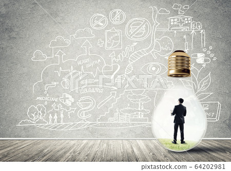Businessman trapped in bulb Businessman trapped in bulb 64202981
