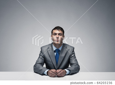 Handsome man folded hands and having serious face 64203156