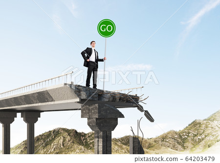 Young businessman holding street safety sign. 64203479
