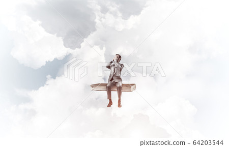 Young man on book in blue sky do not want to see anything Young man on book in blue sky do not want to see anything 64203544