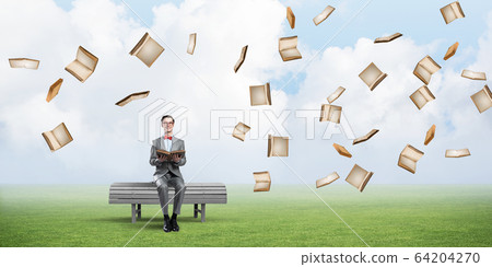 Young businessman or student studying the science and books fly around Young businessman or student studying the science and books fly around 64204270