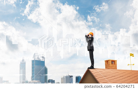 Engineer man standing on roof and looking in binoculars. Mixed media Engineer man standing on roof and looking in binoculars. Mixed media 64204271