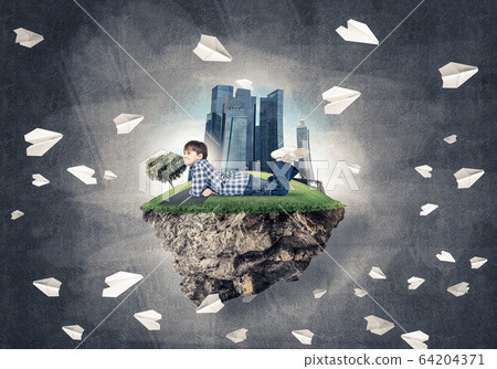 Cute boy of school age lying on grass and smiling to this great 64204371