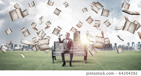 Businessman in summer park announcing something in loudspeaker a Businessman in summer park announcing something in loudspeaker a 64204392