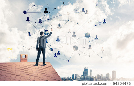 Businessman on house roof presenting networking and connection c 64204476