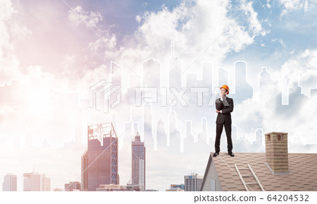Engineer man standing on roof and looking away. Mixed media Engineer man standing on roof and looking away. Mixed media 64204532
