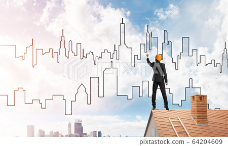 Man architect draw silhouette of modern city on blue sky. Mixed media 64204609