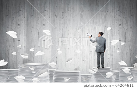 Businessman standing with megaphone. Businessman standing with megaphone. 64204611