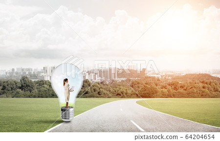 Businesswoman inside light bulb Businesswoman inside light bulb 64204654