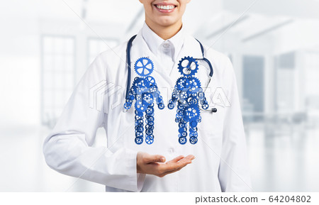 Close of female medicine worker showing in palm gear couple figures 64204802