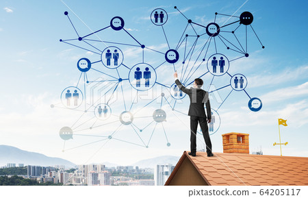 Businessman on house roof presenting networking and connection concept. Mixed media 64205117