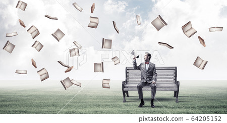 Businessman in summer park announcing something in loudspeaker a Businessman in summer park announcing something in loudspeaker a 64205152