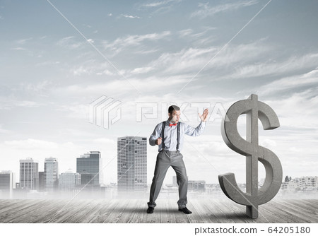 Determined banker man against modern cityscape breaking dollar concrete figure Determined banker man against modern cityscape breaking dollar concrete figure 64205180