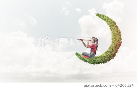 Concept of careless happy childhood with girl on green moon Concept of careless happy childhood with girl on green moon 64205184