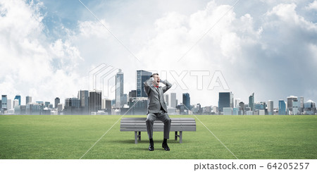 Young man in suit in park dont want to hear anything 64205257