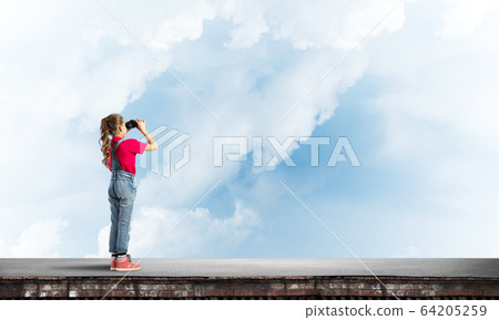 Concept of careless happy childhood with girl of school age looking in future Concept of careless happy childhood with girl of school age looking in future 64205259