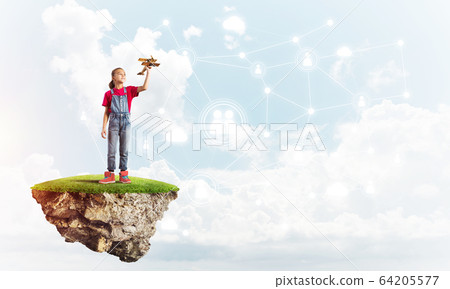Concept of careless happy childhood with girl dreaming about something Concept of careless happy childhood with girl dreaming about something 64205577