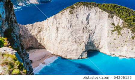 Close up of Navagio beach, Zakynthos island, Greece. Shipwreck bay with turquoise water and white sand beach. Famous landmark location in Greece Close up of Navagio beach, Zakynthos island, Greece. Shipwreck bay with turquoise water and white sand beach. Famous landmark location in Greece 64206185