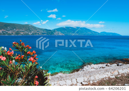 Panorama of crystal clear transparent blue turquoise teal Mediterranean seascape in Fiskardo town. Kefalonia, Ionian islands, Greece Panorama of crystal clear transparent blue turquoise teal Mediterranean seascape in Fiskardo town. Kefalonia, Ionian islands, Greece 64206201