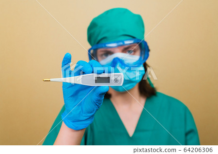 Female Doctor with white thermometer in hand Female Doctor with white thermometer in hand 64206306