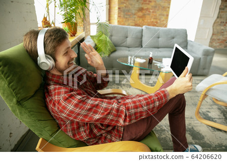 Caucasian man staying at home during quarantine because of coronavirus spreading 64206620