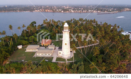 Aerial drone view of the old lighthouse of white stone located on the island Aerial drone view of the old lighthouse of white stone located on the island 64206648