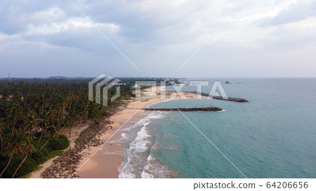 Beautiful beach with blue water and palm on Sri Lanka Beautiful beach with blue water and palm on Sri Lanka 64206656