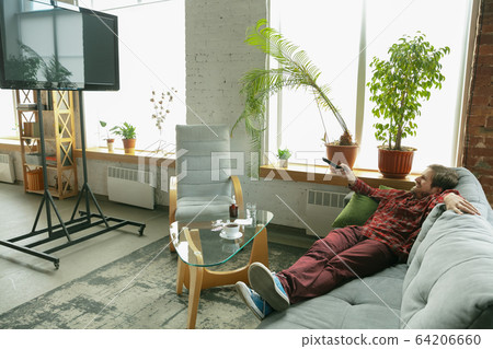 Caucasian man staying at home during quarantine because of coronavirus spreading 64206660