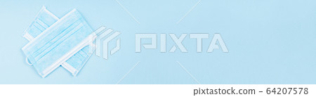 Face masks on blue as symbol of covid19 pandemic Face masks on blue as symbol of covid19 pandemic 64207578