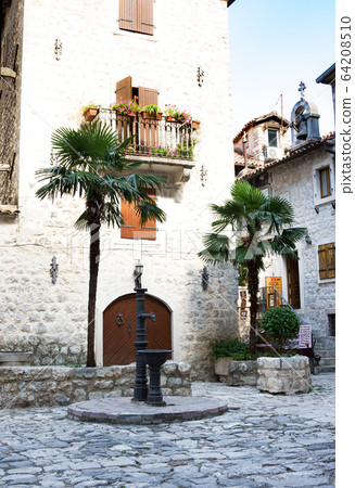 Old drinking water pump in the old town of Kotor, 64208510