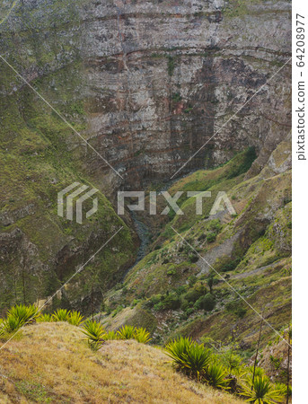 Santo Antao, Cape Verde. Mountain ridge with dry waterfall of canyon with steep cliff and winding riverbed with lush green vegetation Santo Antao, Cape Verde. Mountain ridge with dry waterfall of canyon with steep cliff and winding riverbed with lush green vegetation 64208977